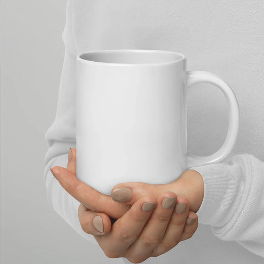 Person holding a large white glossy ceramic mug with handle on right side